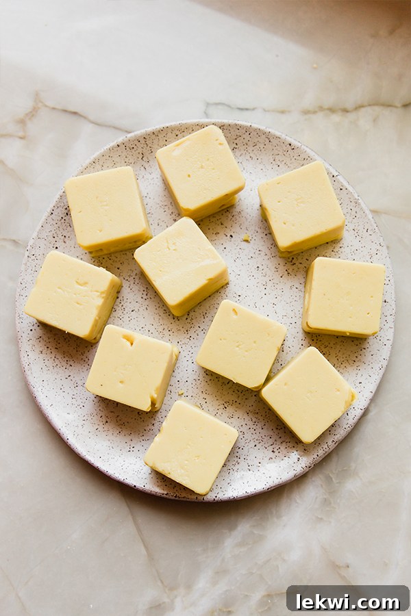 Freshly made chickpea tofu cubes arranged neatly on a plate.