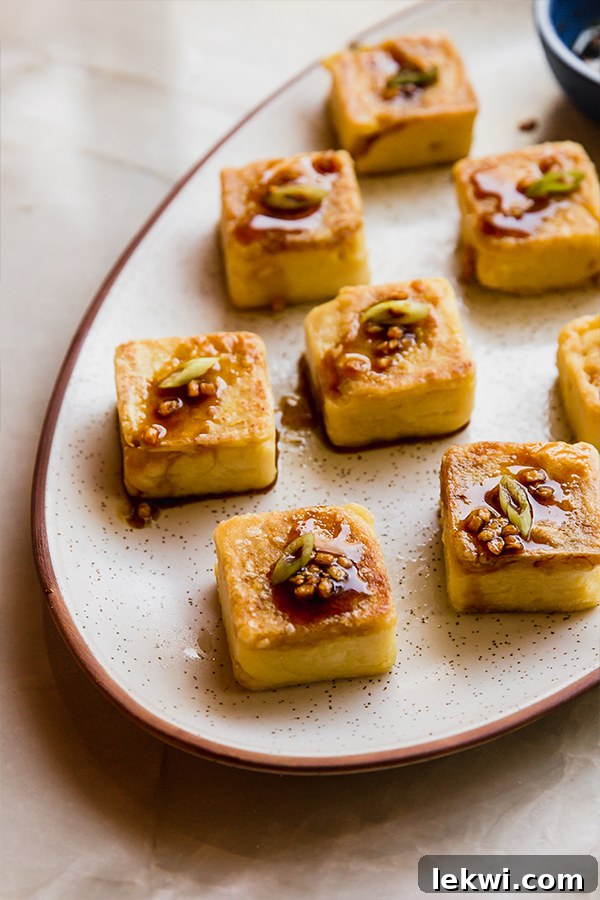 Delicious chickpea tofu topped with a sweet and savory honey garlic sauce.