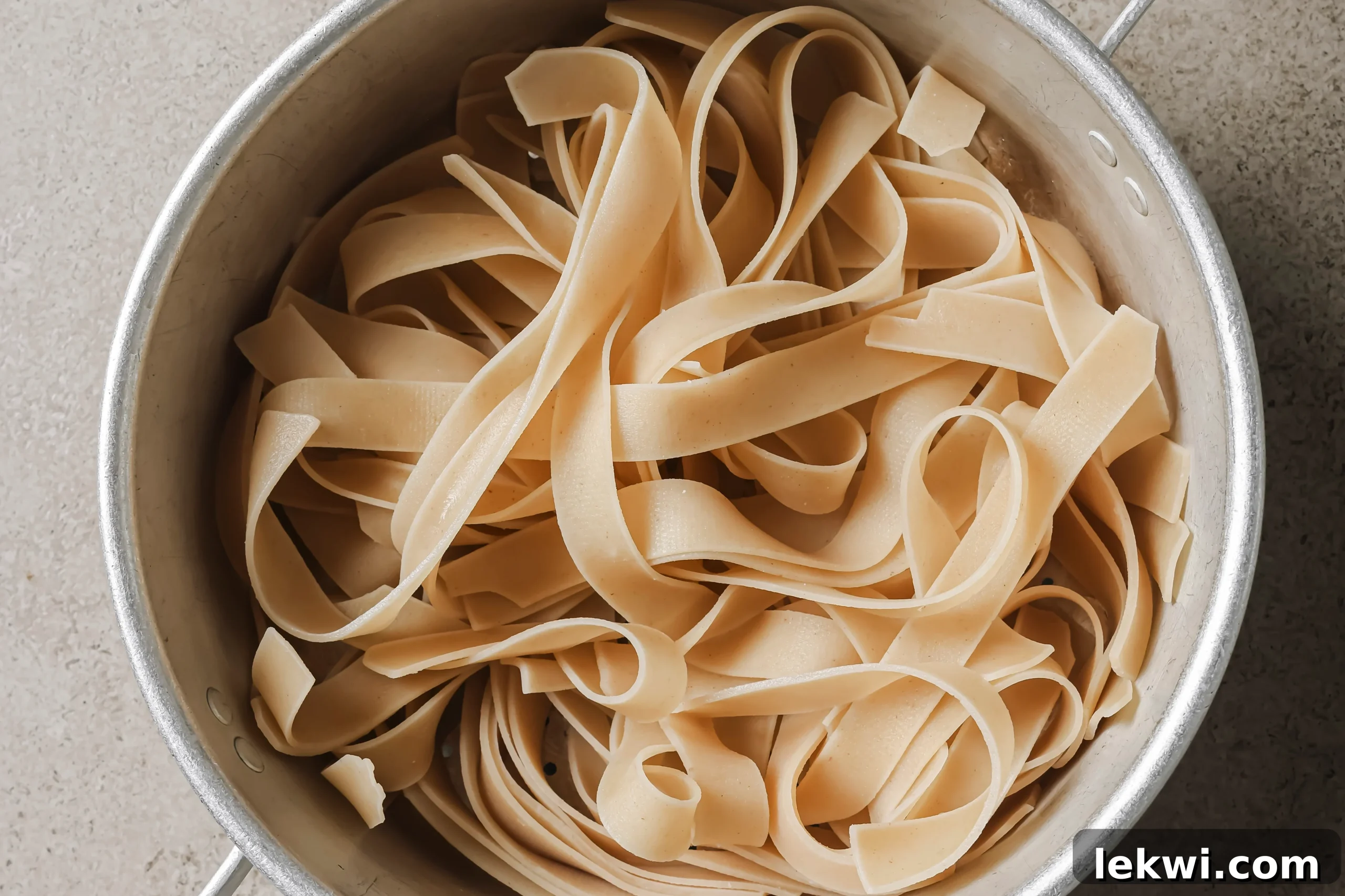 Fully cooked rice noodles in a pot. 