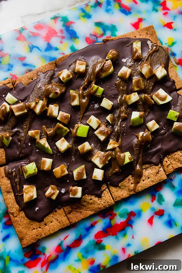 Caramel apple graham cracker bark on a colorful table.