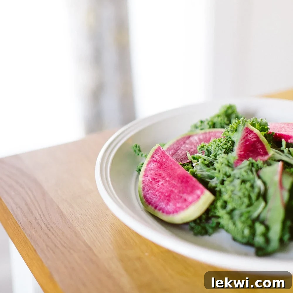 From Repair to Resilience: Nurturing Your Gut at Every Healing Milestone 2 Kale salad with radishes on a white plate.