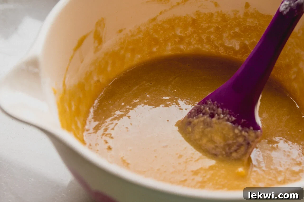 Preparing the fluffy Christmas tree cake batter in a large mixing bowl.