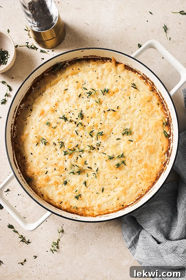 French onion shepherd's pie topped with herbs in a Dutch oven.