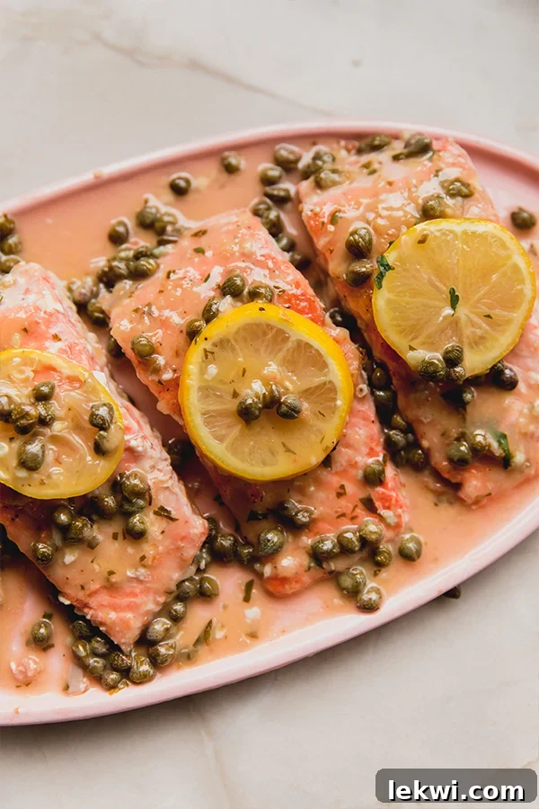 Lemon slices and capers on salmon piccata.