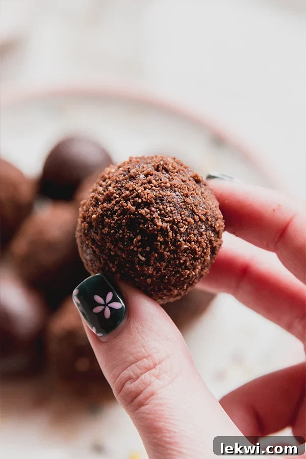 One thin mint truffle being held in a hand.