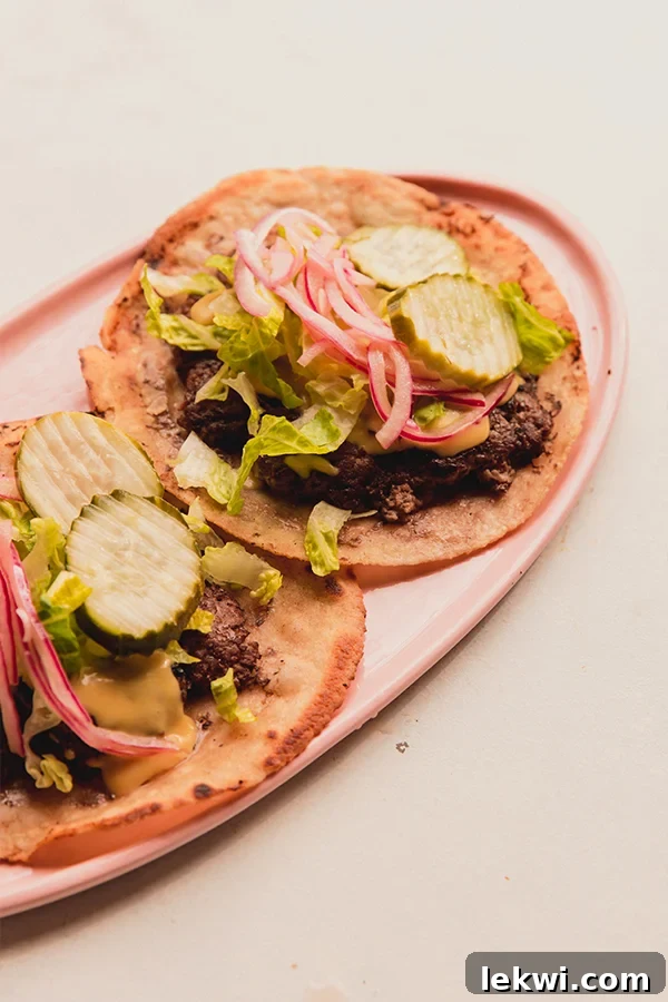 Two smash burger tacos on a plate.