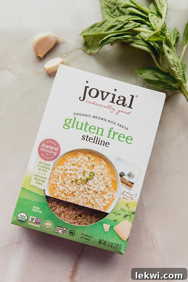 A selection of fresh ingredients including a bag of Jovial Gluten Free Stelline pasta, fresh basil, and parsley, ready to be transformed into basil pesto stelline.