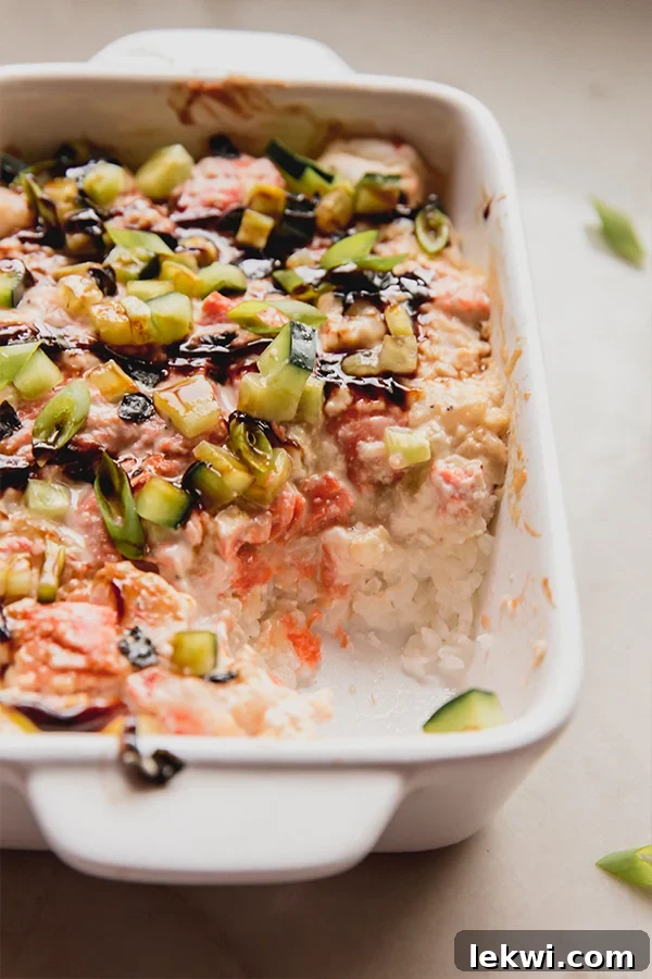A mini sushi bake with a scoop taken out of it.