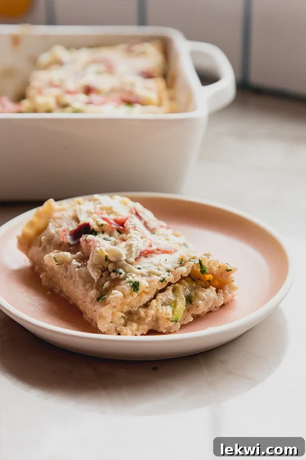 Creamy Gluten-Free Chicken Alfredo Lasagna Roll Ups 4 A beautifully plated individual serving of Chicken Alfredo Lasagna Roll-Ups, garnished with fresh herbs and ready to be enjoyed as a gourmet yet comforting meal.