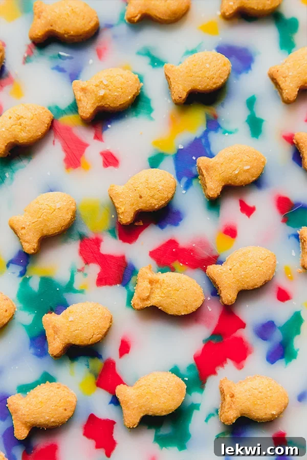 Dairy free gold fish on a colorful cutting board.