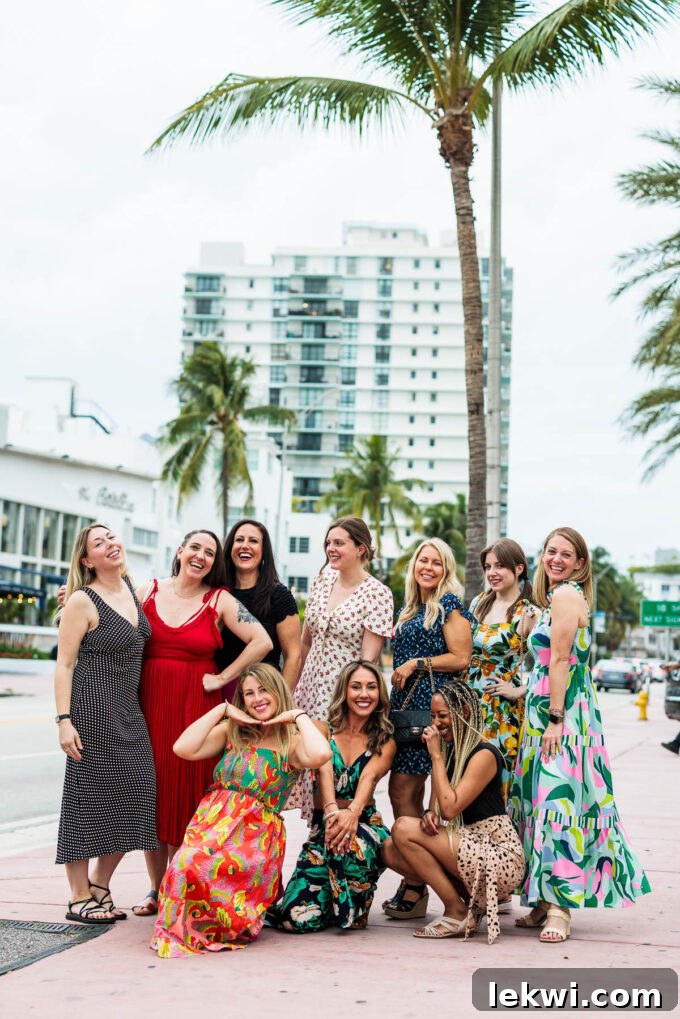 A group of 10 smiling food bloggers in Miami with buildings and palm trees in the background, enjoying the Fresh Air Retreat.