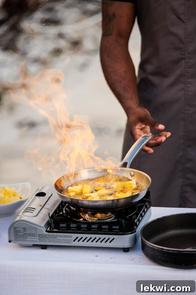 Bananas foster cooking in a pan, capturing the warm, caramelized preparation of the rum-infused dessert by Chef Trimell.