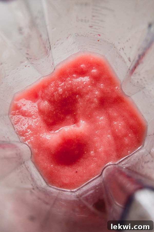Frozen watermelon margarita mocktail blended in a blender.