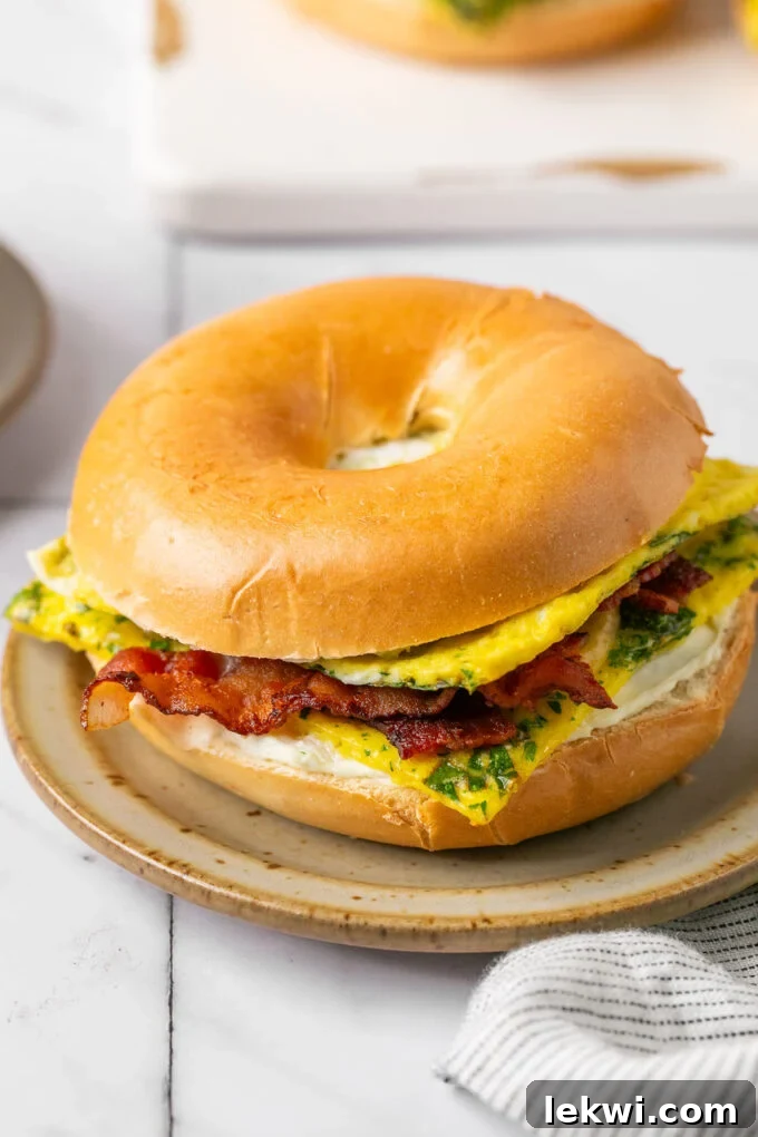 A stack of beautifully prepared gluten-free and dairy-free sheet pan egg breakfast sandwiches, wrapped individually for meal prep convenience.