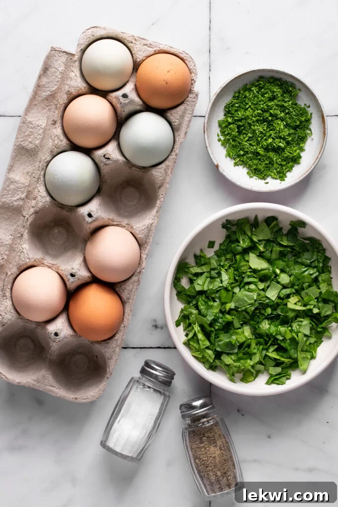 Separate bowls containing whisked eggs, fresh spinach, chopped parsley, and salt and pepper, ready for mixing.