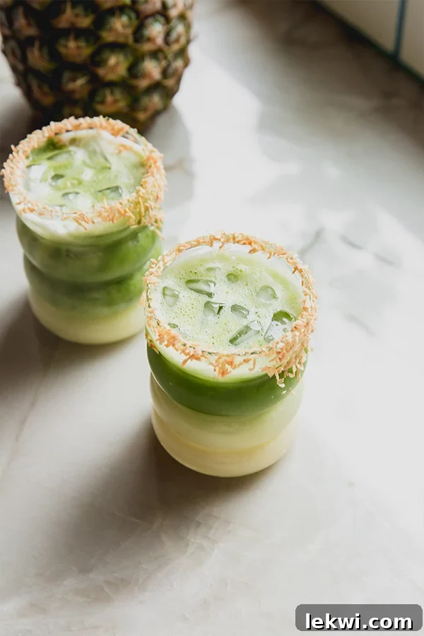 Two matcha pina coladas with a toasted coconut rim.