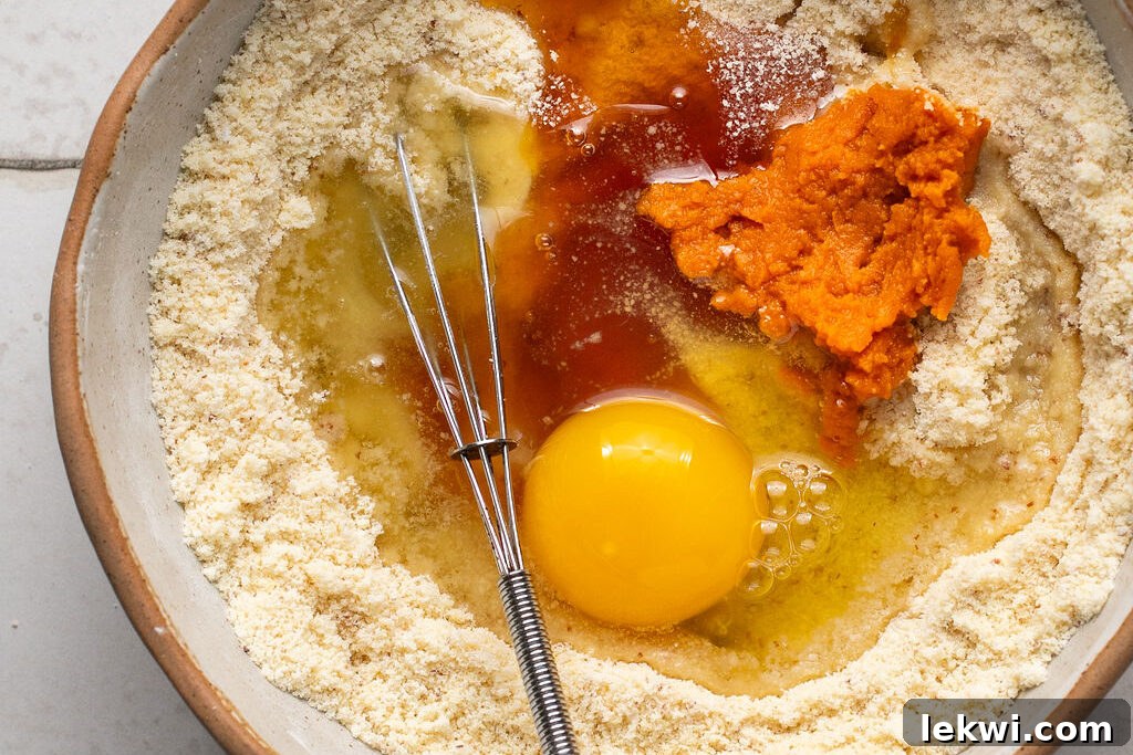 Ingredients for corn dog muffins being mixed in a bowl, showcasing the consistency of the batter.