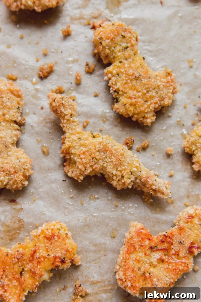 Gluten-free dino nuggets on parchment paper.