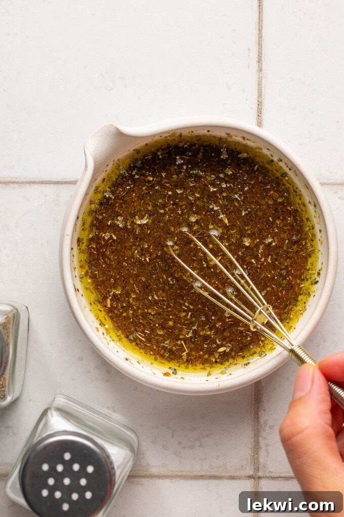 The dressing for sub in a tub salad after mixing, showing a well-combined vinaigrette.