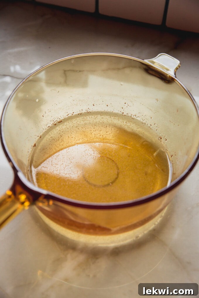 A bowl filled with the pre-gummy liquid mixture, showcasing its smooth, amber consistency before setting into delicious apple cider vinegar gummies.