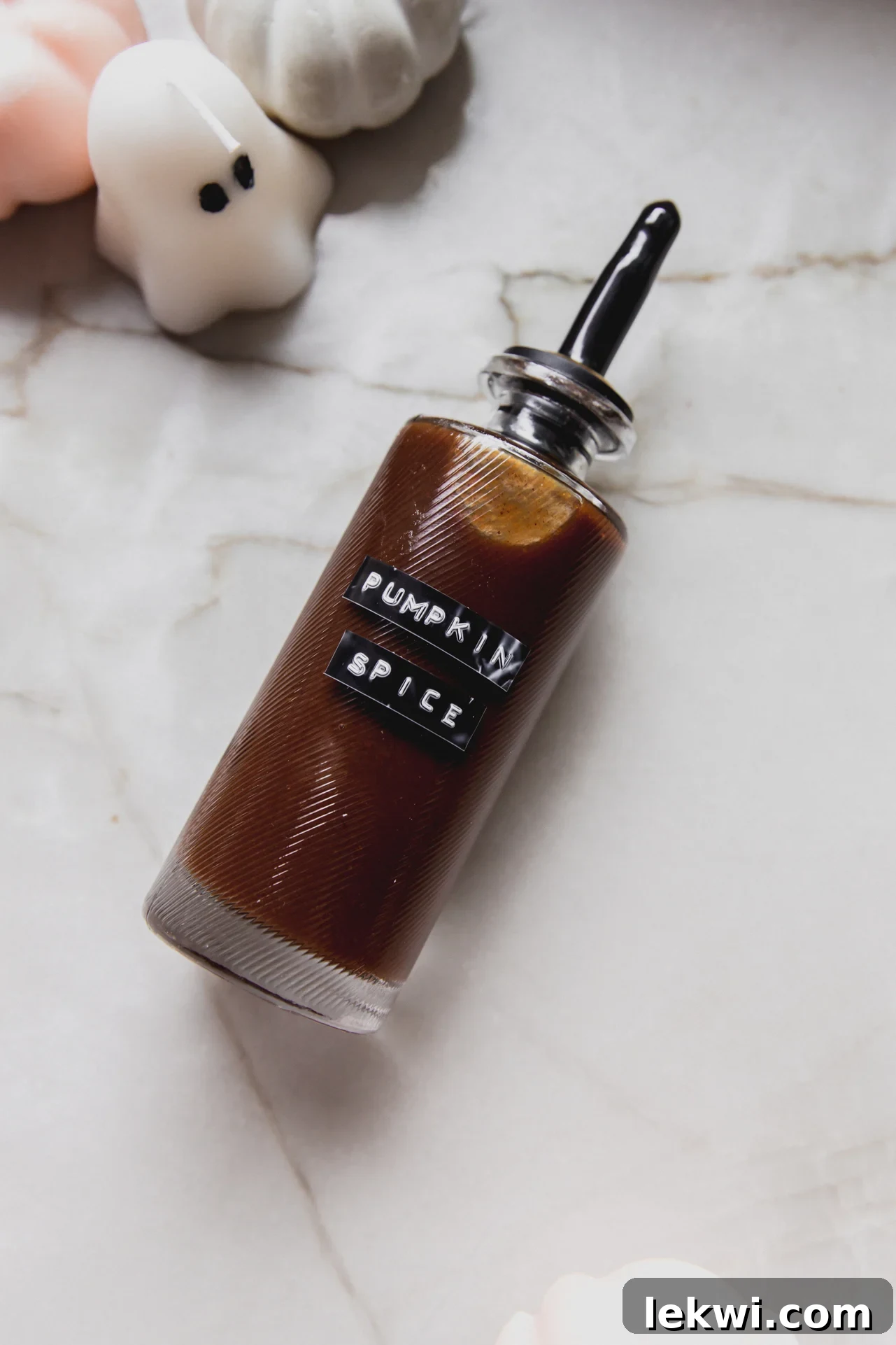 A beautifully labeled glass bottle of homemade pumpkin spice syrup, ready to transform your beverages.