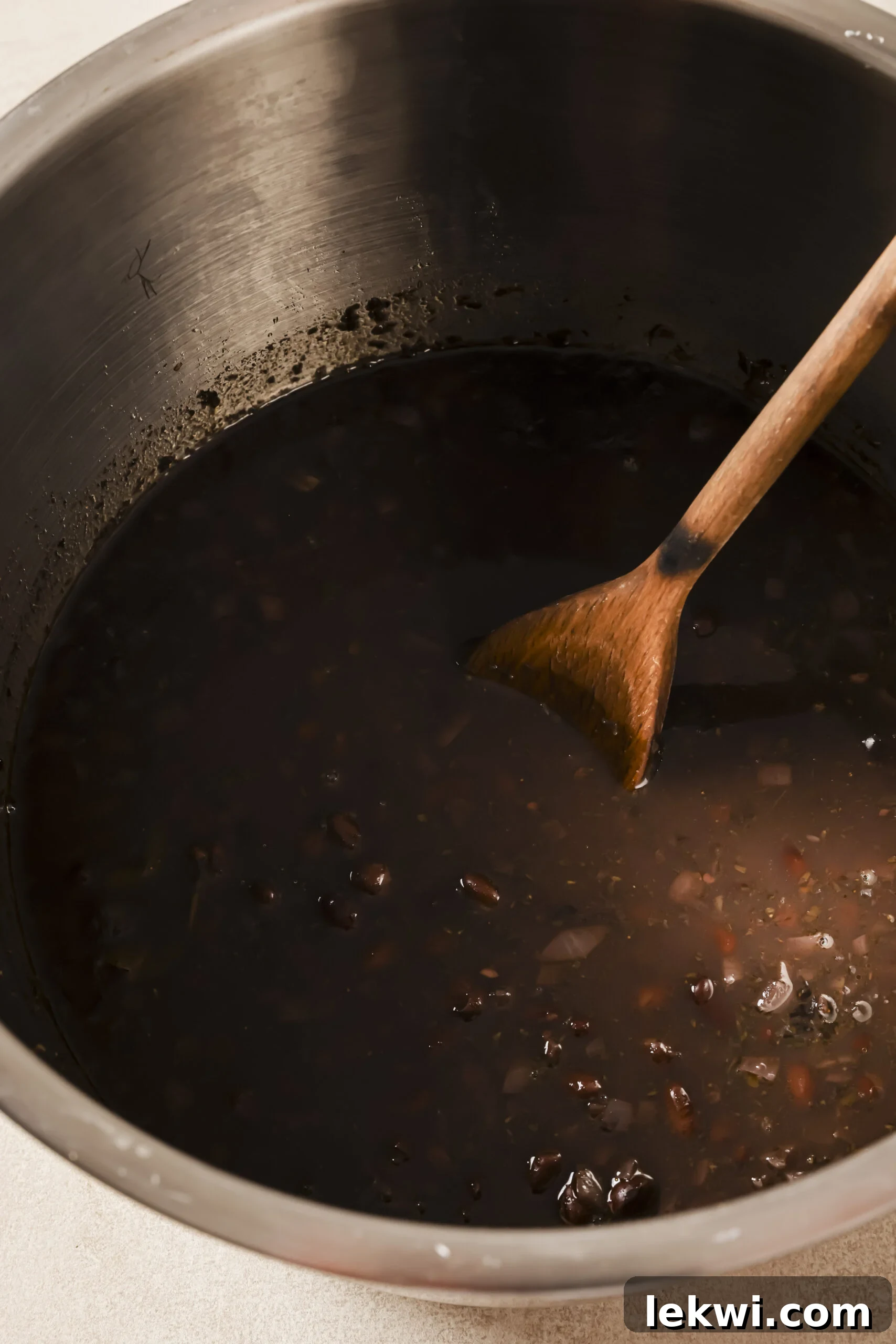 Cooked refried beans in an instant pot with extra broth.