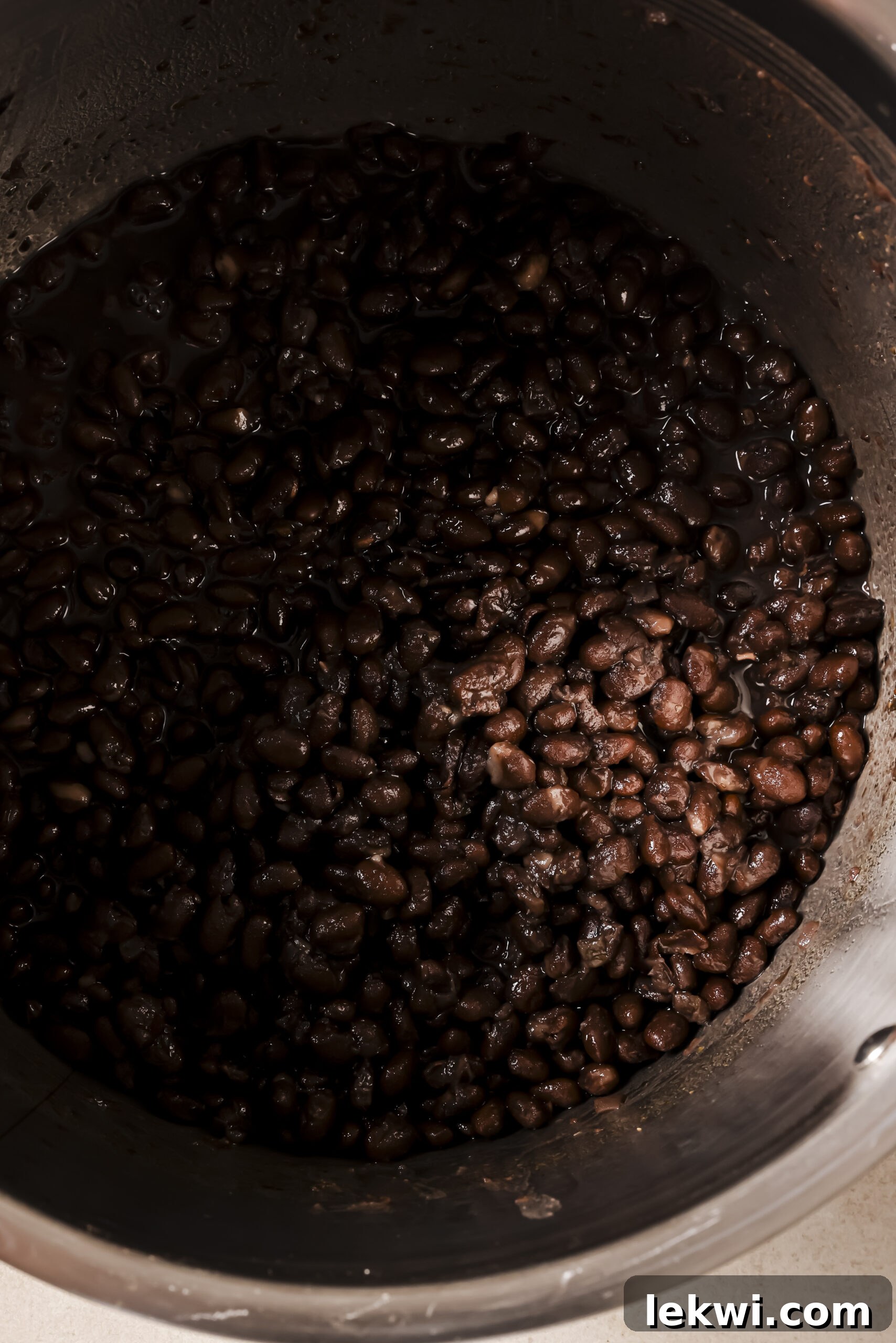 Cooked refried beans in an instant pot with extra broth strained out.