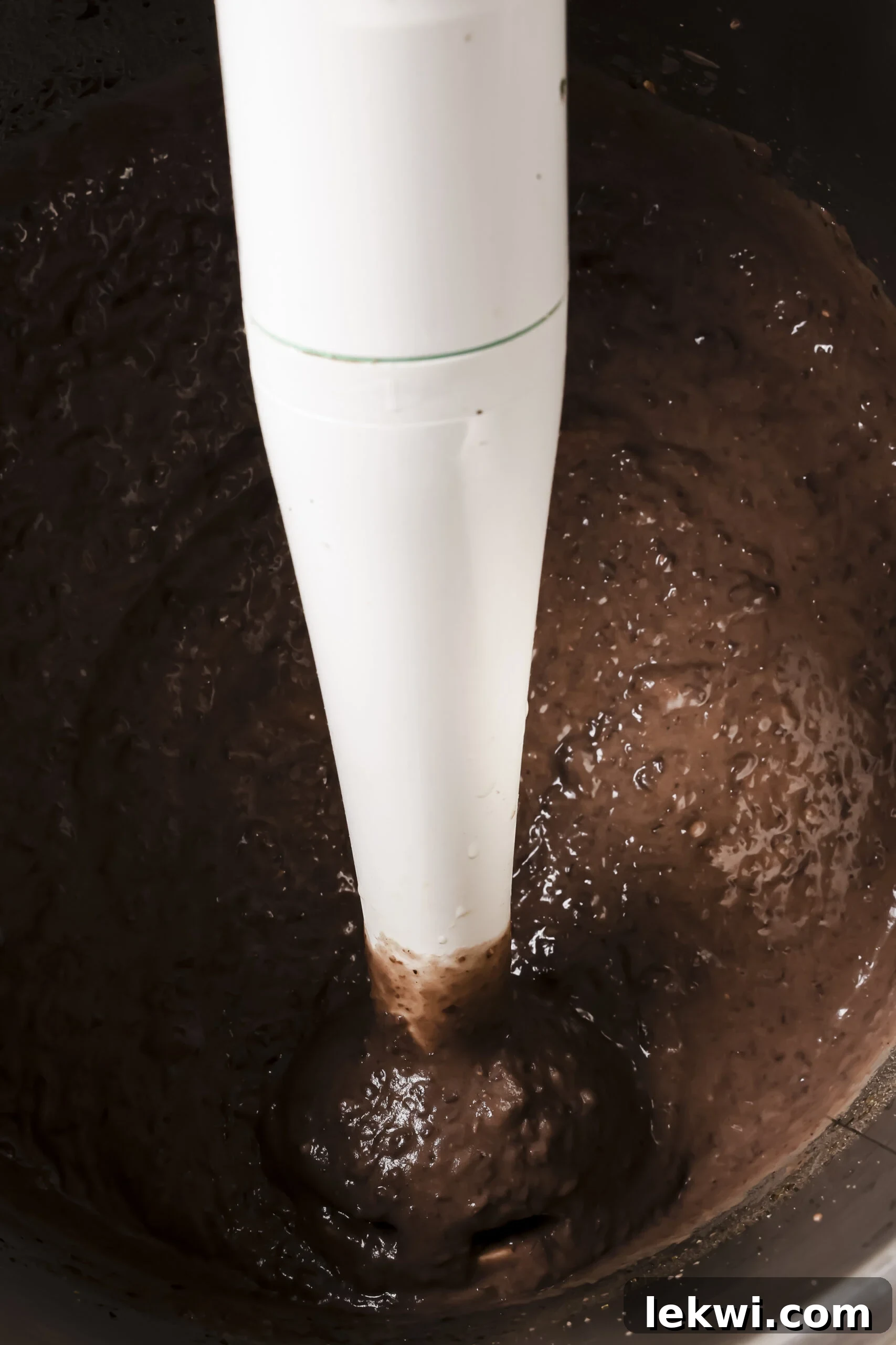 Cooked refried beans in an instant pot with extra broth strained out and blending with an immersion blender.