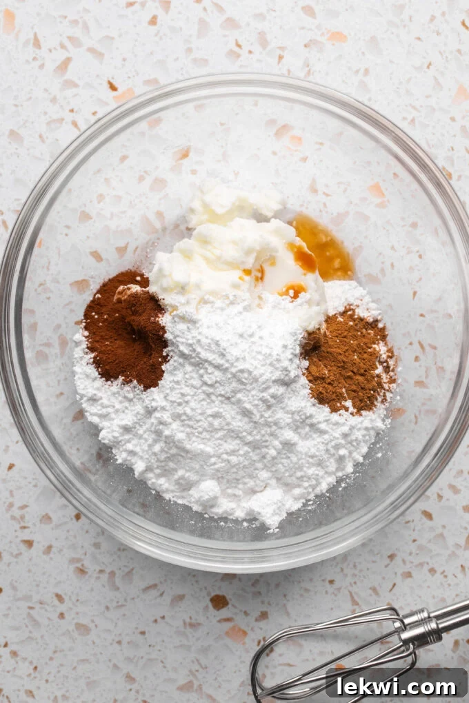 Ingredients for pumpkin spice icing laid out, including palm shortening, powdered sugar, and espresso powder, before mixing.