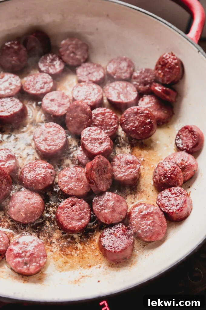 Sausage chopped and cooked in a pan.