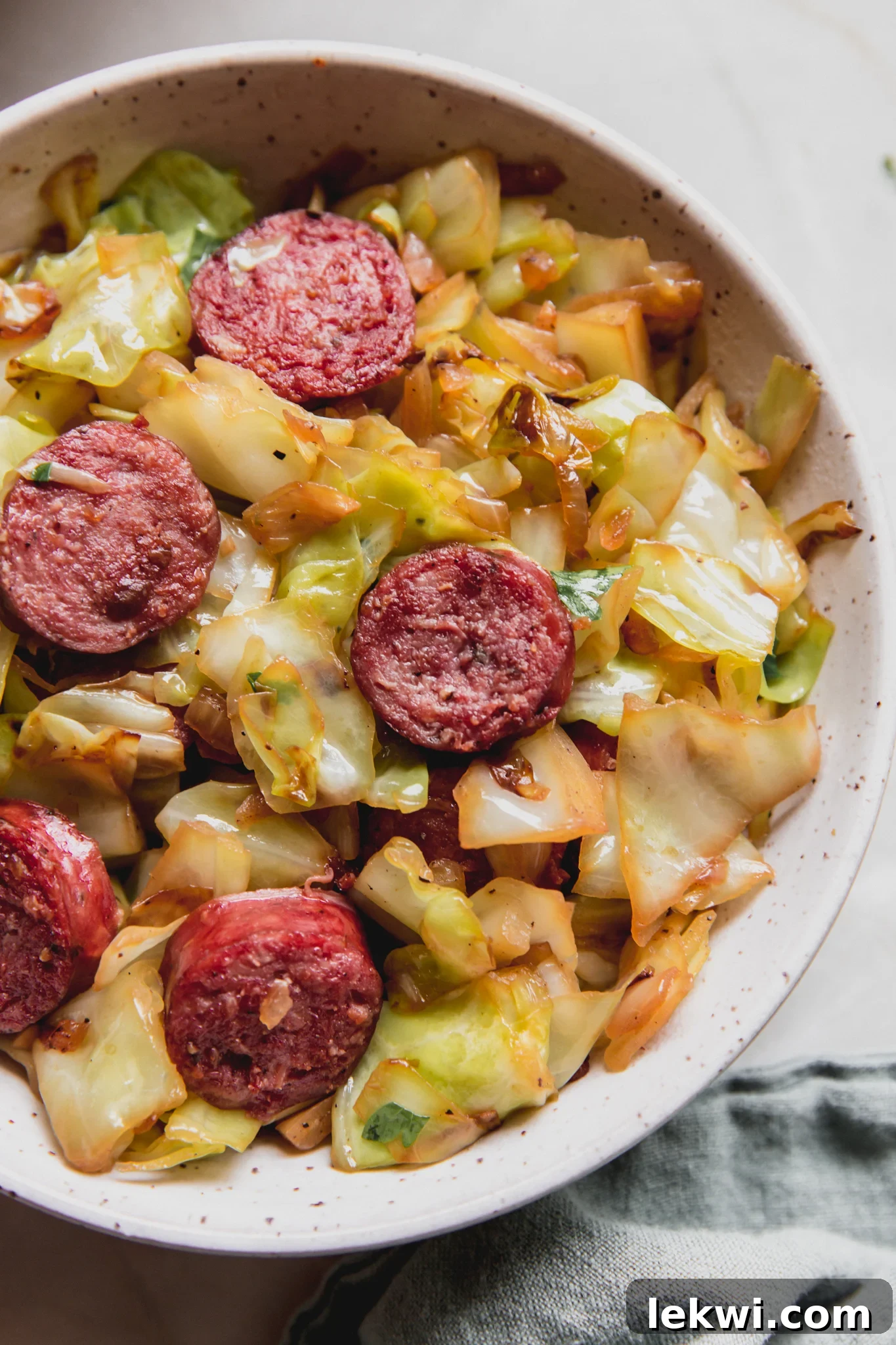 One pan southern fried cabbage and sausage in a bowl.