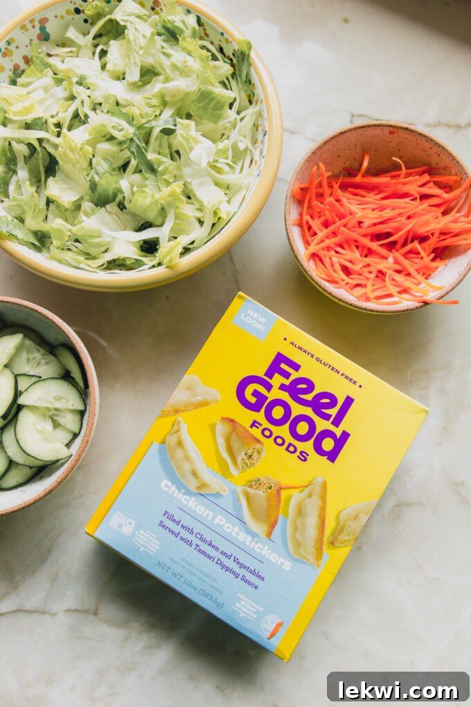 Various potsticker salad ingredients laid out in small bowls, alongside a box of gluten-free potstickers and the dressing components.