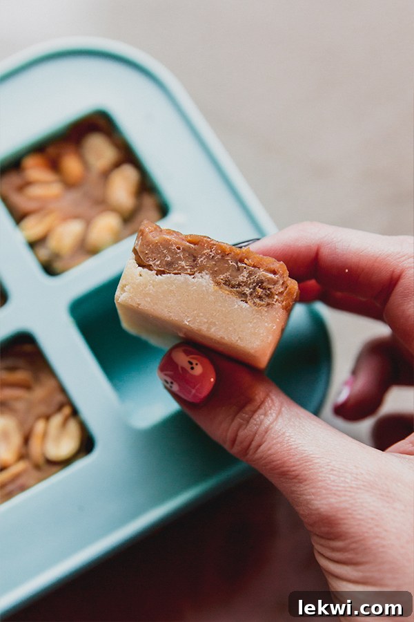 Two-layered Snickers bars after being set in their small mold, showing the distinct nougat and caramel layers.