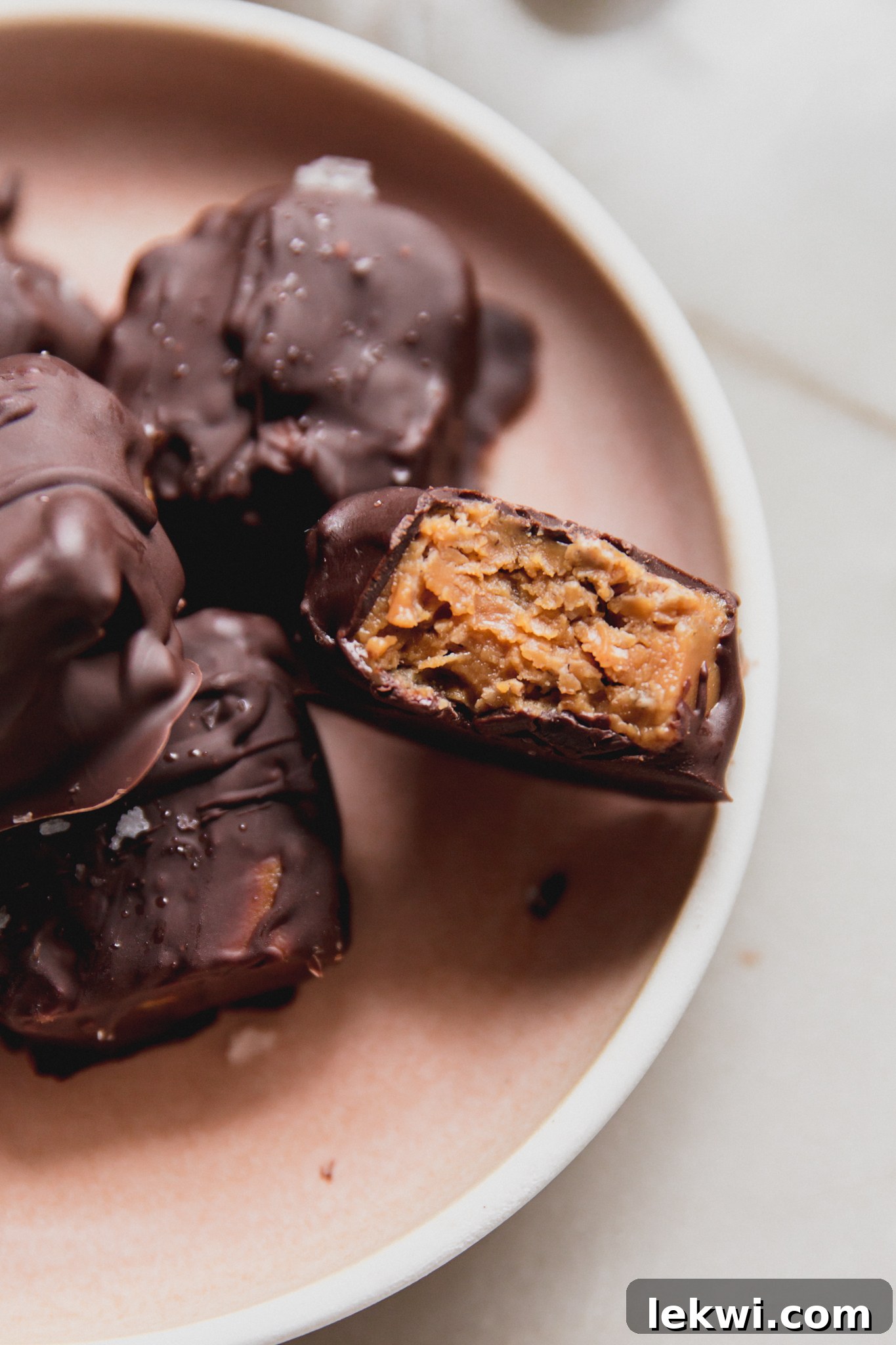 Mini butterfinger copycats on a platter with one bitten in half.