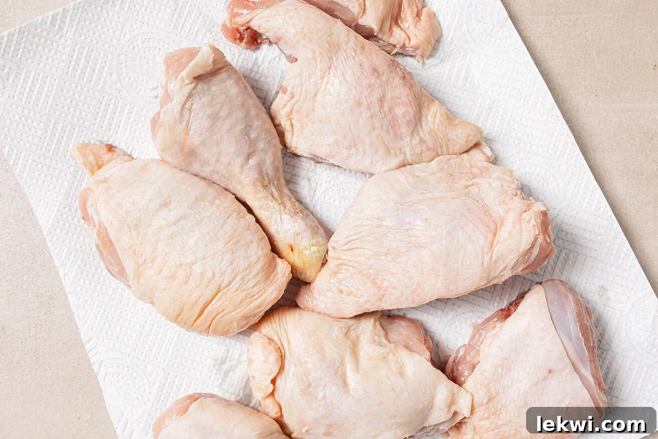 Raw turkey wings on a paper towel, ready for preparation.
