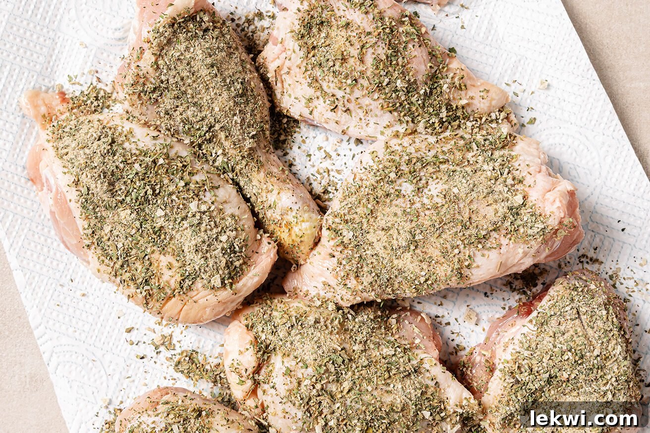 Raw turkey wings coated in a fragrant herb dry rub, ready for baking.