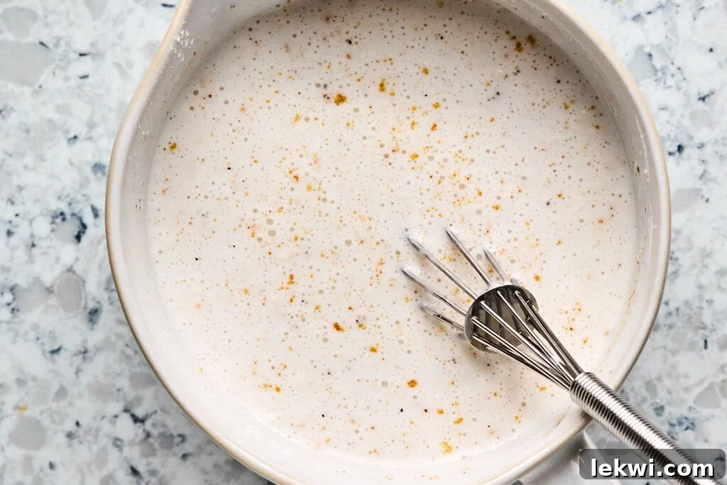 A bowl with coconut milk and arrowroot starch mixed together.