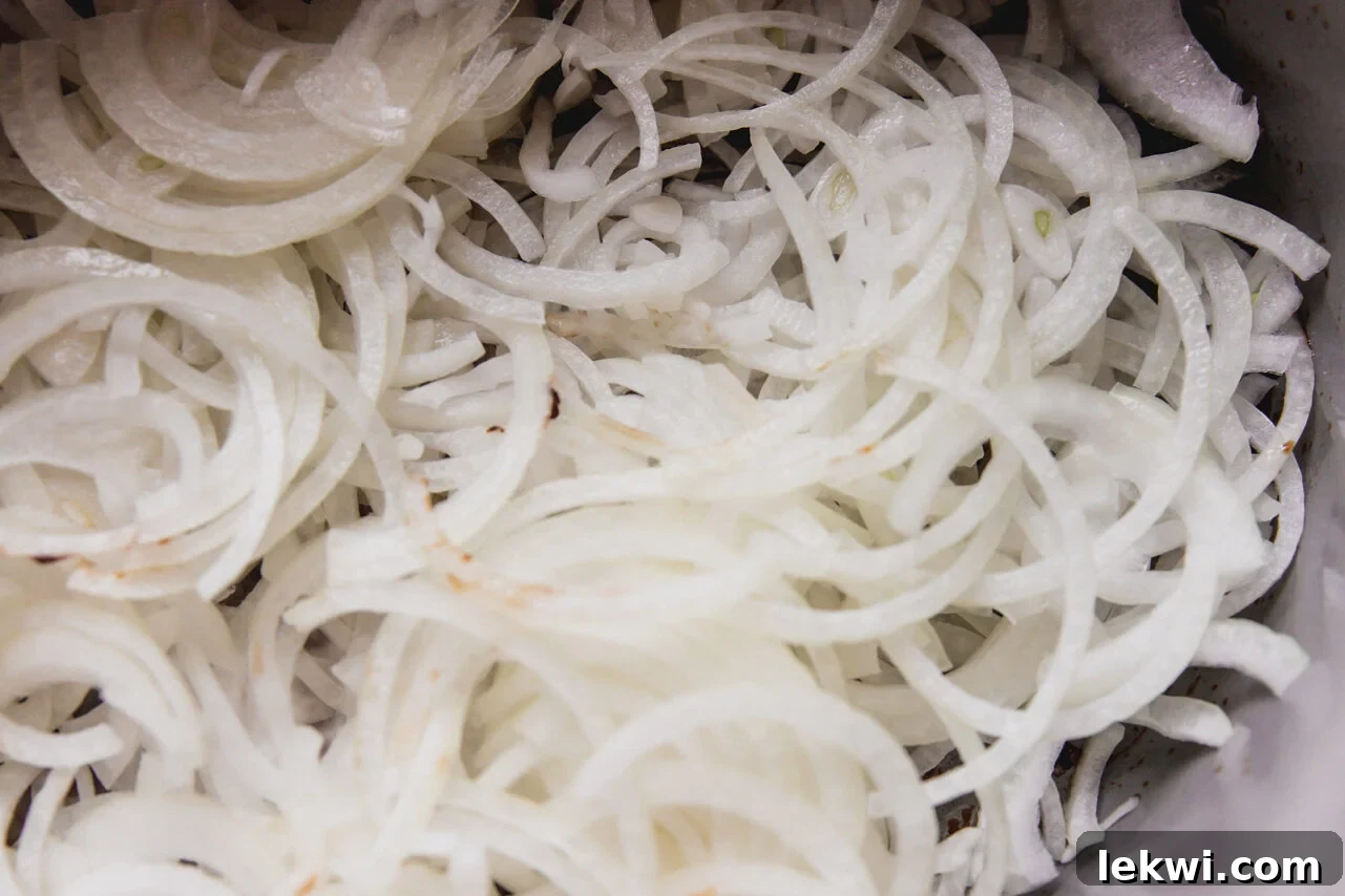 Onions in the Dutch oven before cooking.