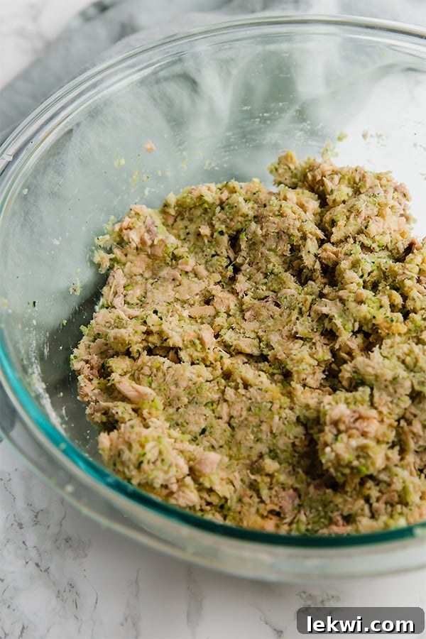 Paleo Salmon Cakes artfully arranged on a rustic plate, garnished with fresh herbs, showcasing their golden-brown crust.