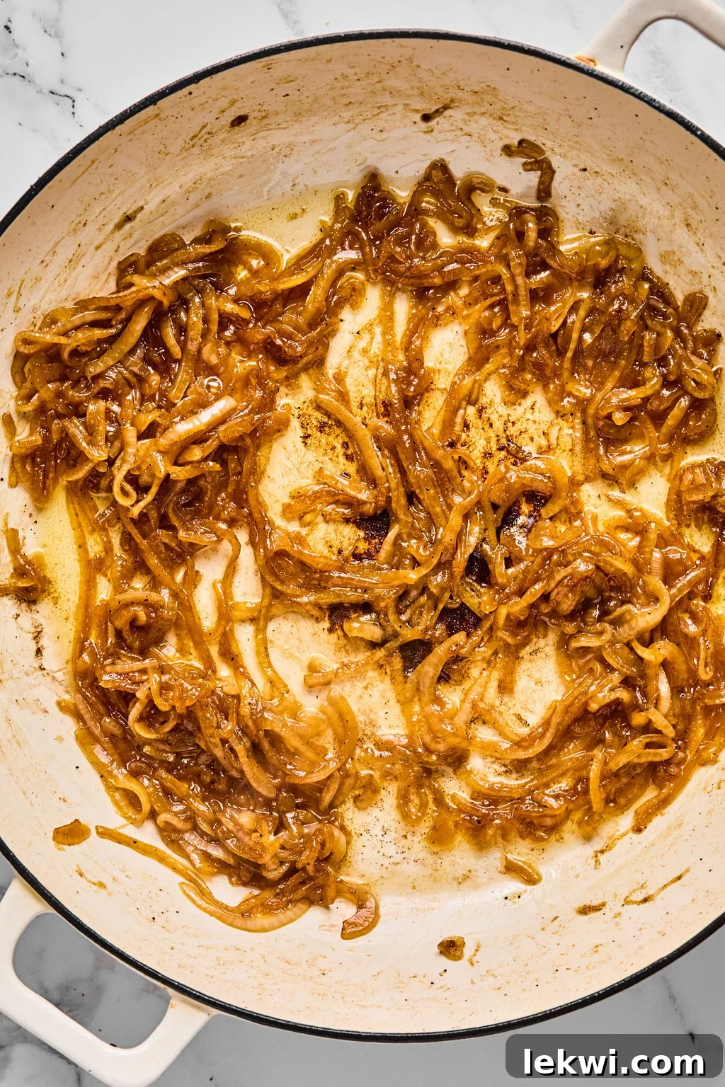 Chicken thighs returned to the pan with rice and broth, ready for baking.