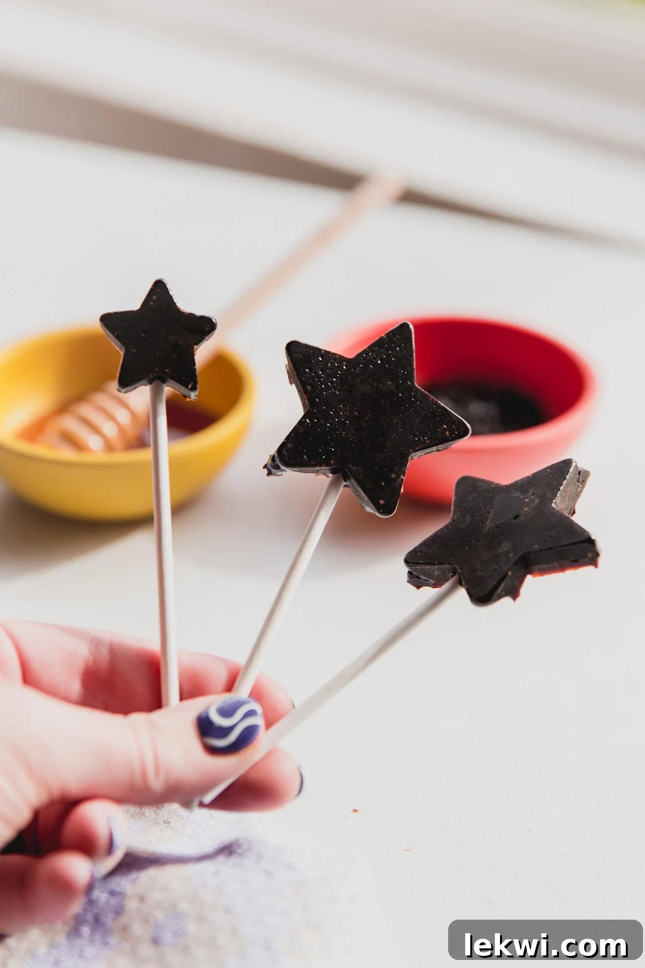 Three star-shaped elderberry lollipops, a natural and fun winter wellness remedy.