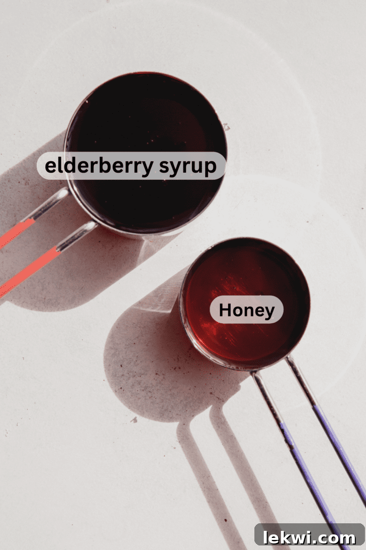 Elderberry lollipop ingredients, elderberry syrup and honey, in two measuring cups.