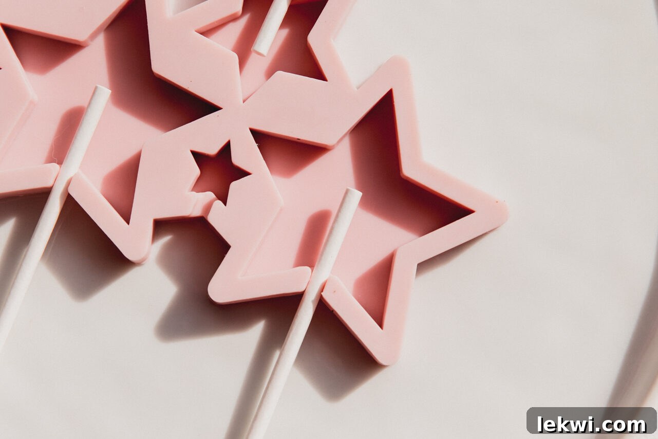 Star-shaped lollipop mold with lollipop sticks already inserted, ready for pouring.