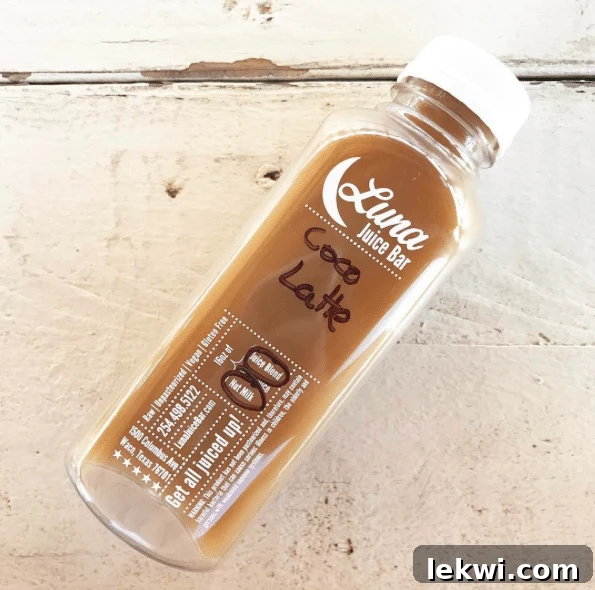 A bottle of Coco Latte from Luna Juice Bar, featuring a dark liquid.
