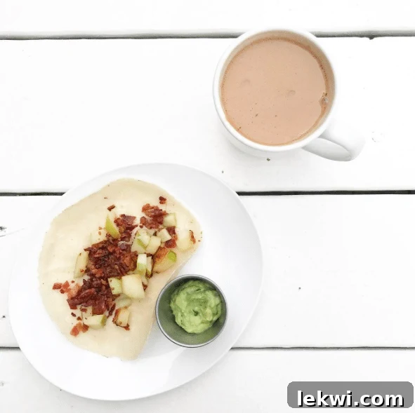 A mug next to a plate featuring a perfectly crafted breakfast taco.