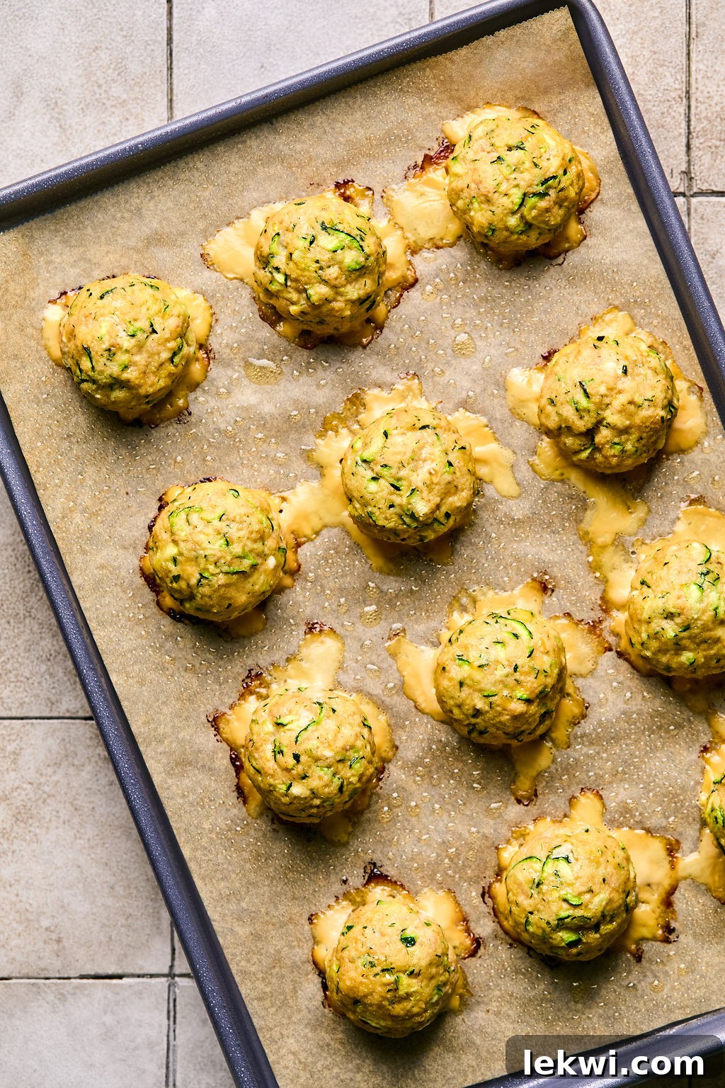 cooked turkey feta meatballs on a parchment lined baking sheet, golden brown and ready to serve