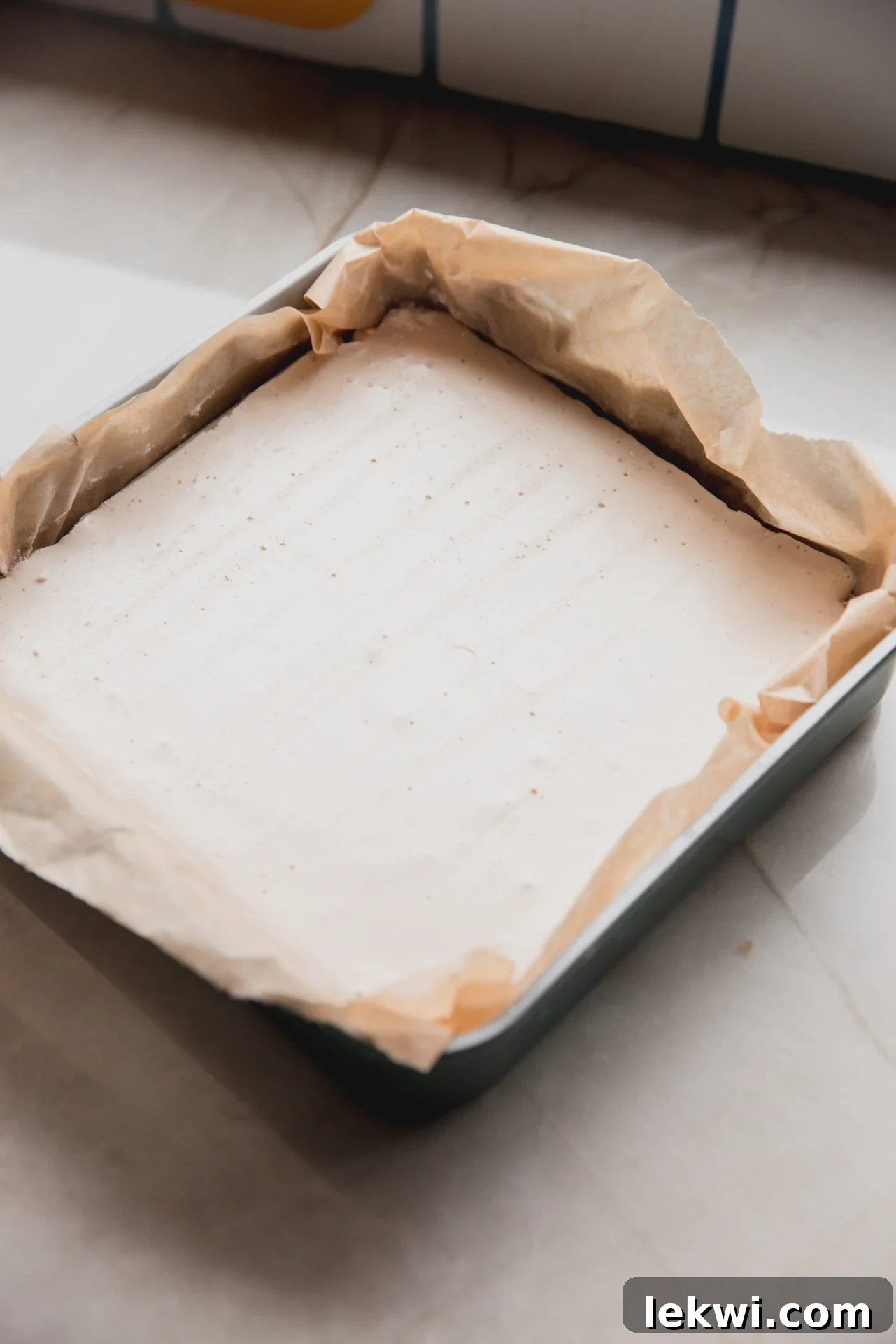 marshmallow mixture in a parchment lined baking dish