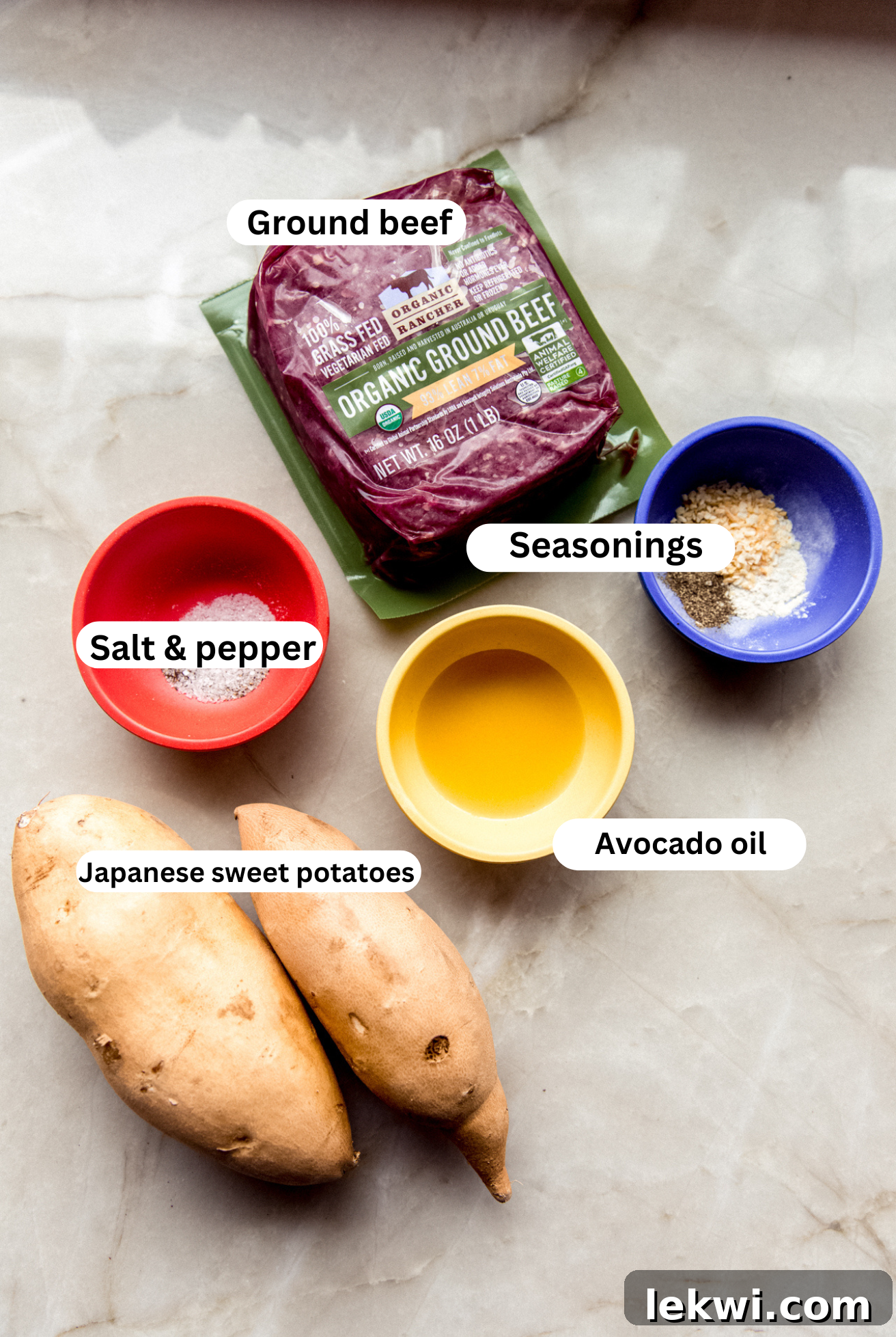 A collection of fresh ingredients including Japanese sweet potatoes, ground beef, and seasonings, ready for making sheet pan burgers and fries.
