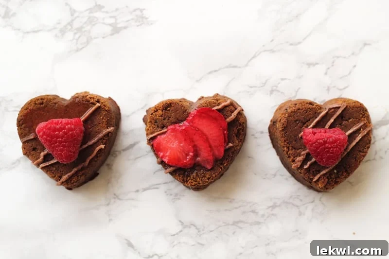 AIP Brownies in heart shapes with icing and strawberries.