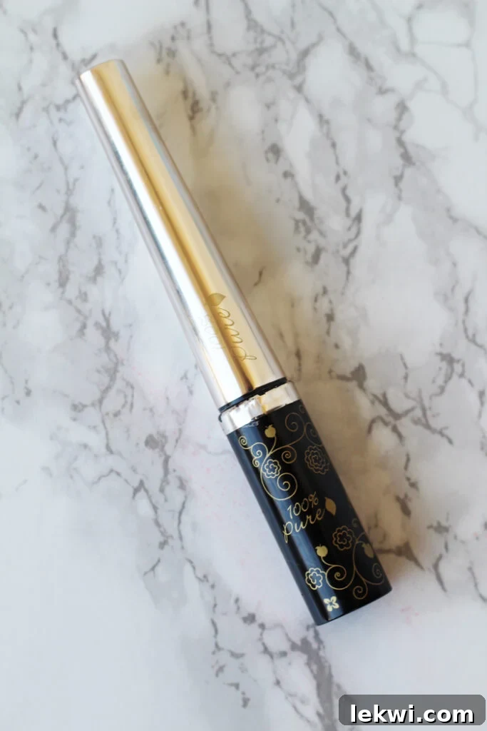 A container of eyeliner on a marble background, showcasing natural beauty.